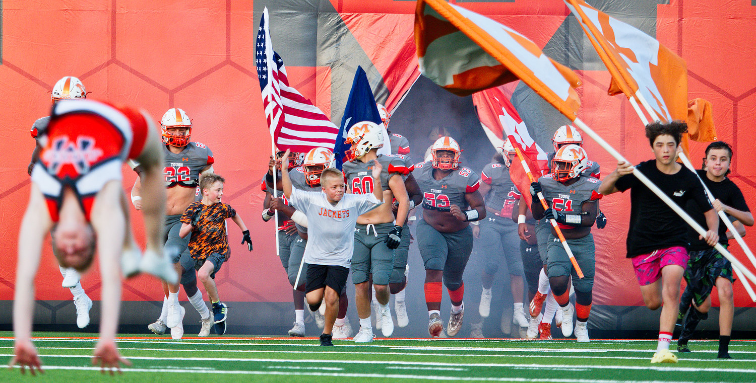 The Mineola Yellowjackets come onto the field to open the new football Friday. [find more football photos]